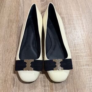 Elegant Tory Burch Cream Flats with Black Bow Accent, brand new and never worn.